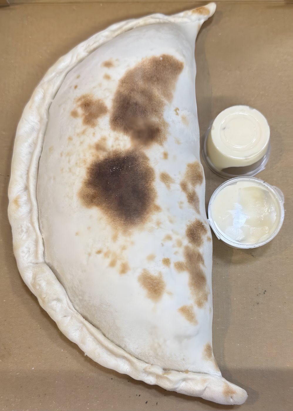 Folded wood-baked calzone with dips