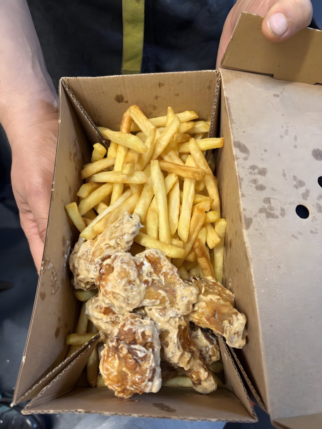 Chicken wings and fries in a box